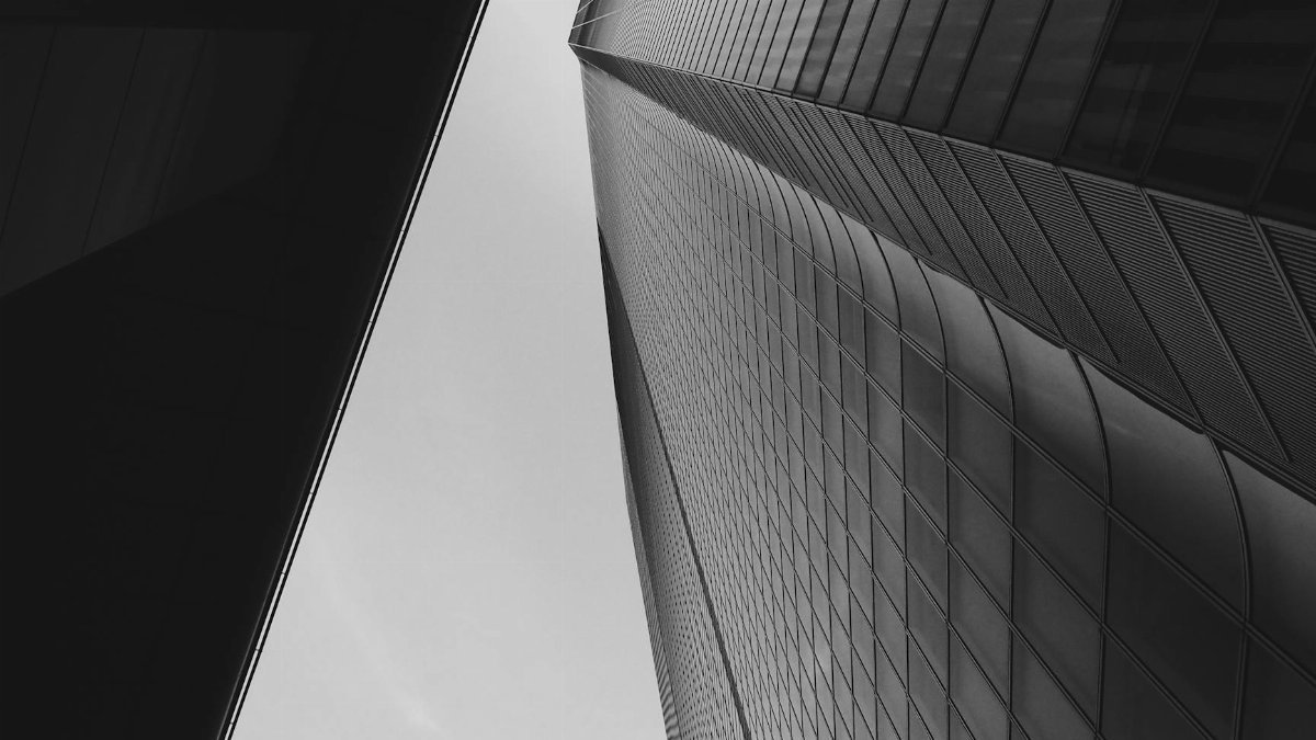 Low angle view of a modern skyscraper in Tokyo, showcasing abstract architectural design.