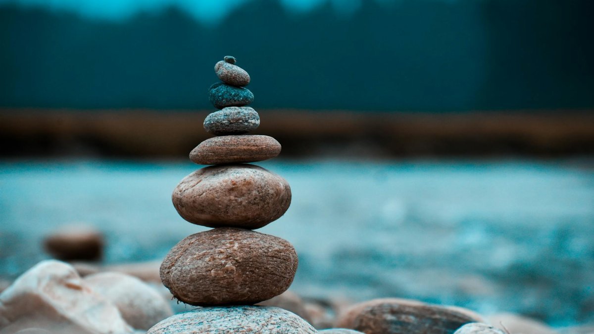 A peaceful arrangement of stacked stones in a natural setting, capturing tranquility in Batabari, India.