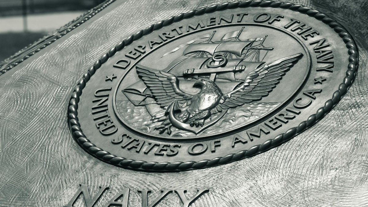 Detailed view of the United States Navy emblem on a monument in Washington D.C., showcasing naval heritage.