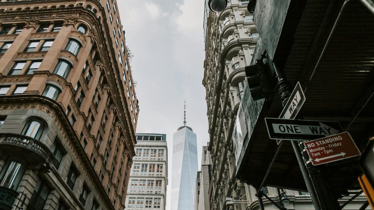 View of One World Trade Center from a busy downtown New York street.
