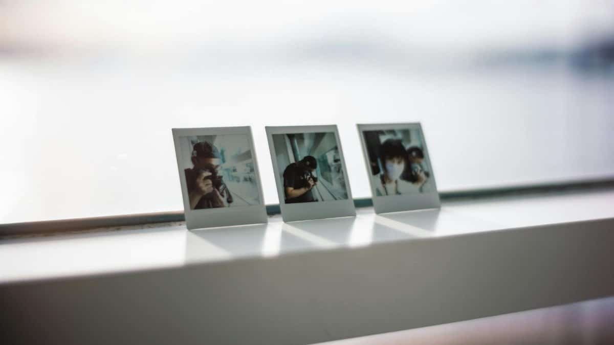 Three Polaroid photos displayed on a windowsill capturing candid memories.
