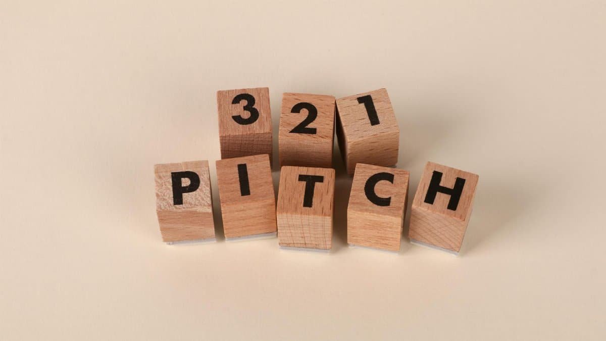 Wooden blocks arranged to spell '3-2-1 Pitch' on a beige background. Perfect for marketing themes.