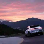 Hyundai Ioniq 5 on a mountain road during a stunning sunset, showcasing modern electric mobility.