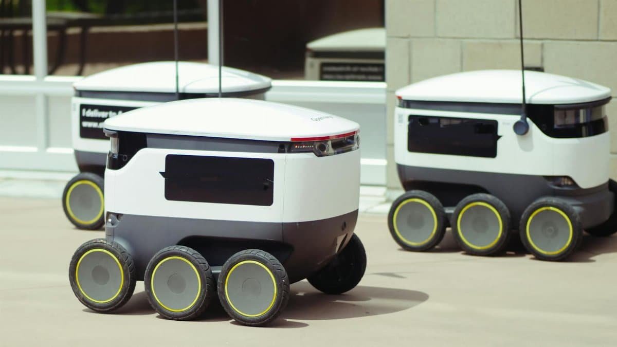 Advanced autonomous delivery robots in an outdoor urban setting, showcasing modern technology.