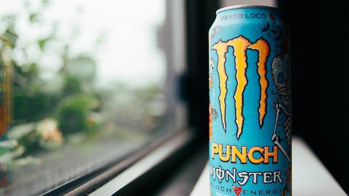 Vibrant image of a Mango Loco Monster Energy drink can on a windowsill.