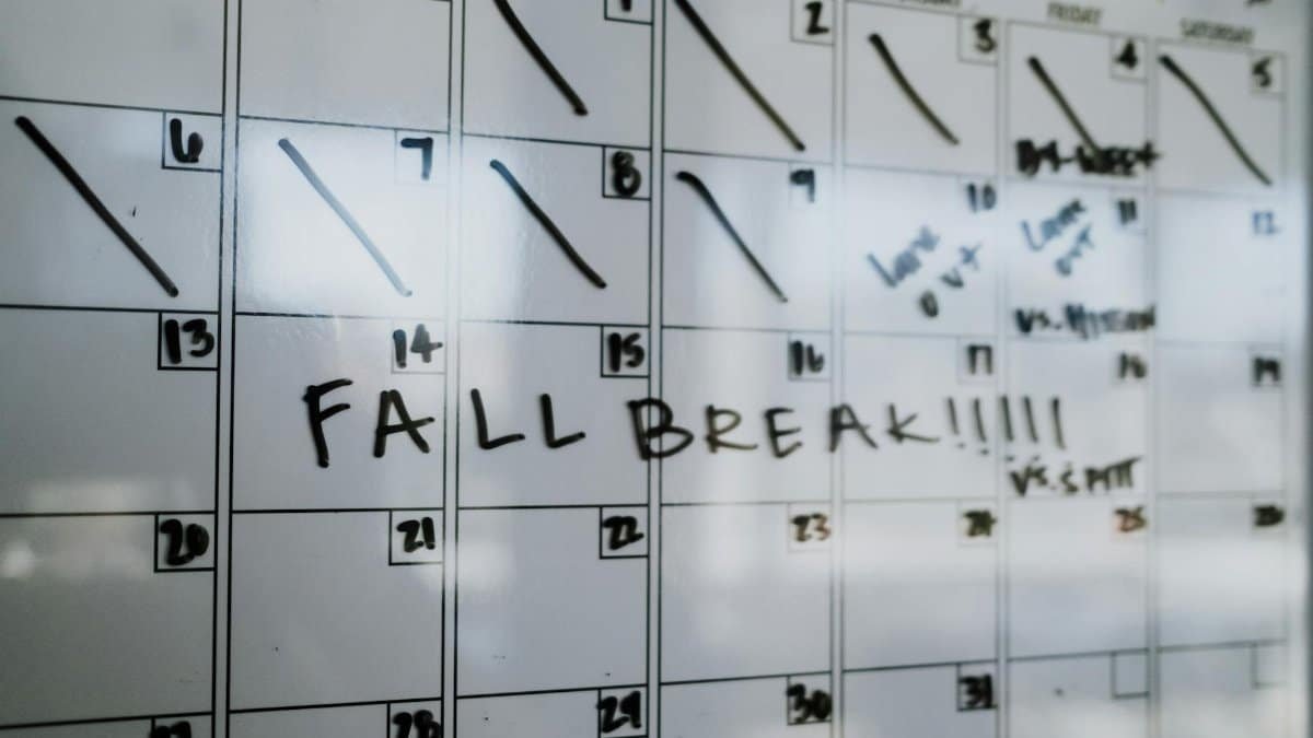 Close-up of a whiteboard calendar with 'FALL BREAK' written in bold letters.