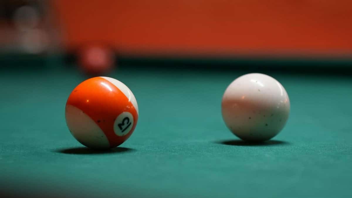 Vibrant shot of the number 13 and cue ball, perfect for pool enthusiasts.