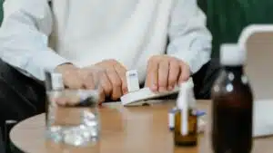 A senior adult preparing medicine doses at home, emphasizing healthcare and telehealth solutions.