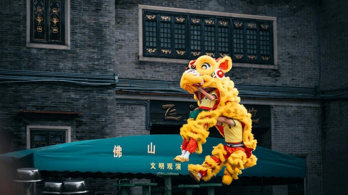 Colorful lion dance performance captured during a cultural festival in an Asian city.