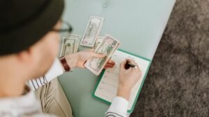 Individual budgeting with US dollars and a planner, focusing on financial planning.