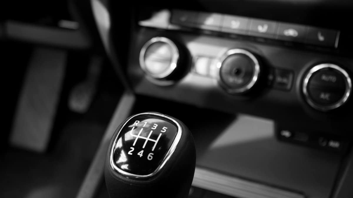 Close-up of a car gear shift in a black and white artistic design.