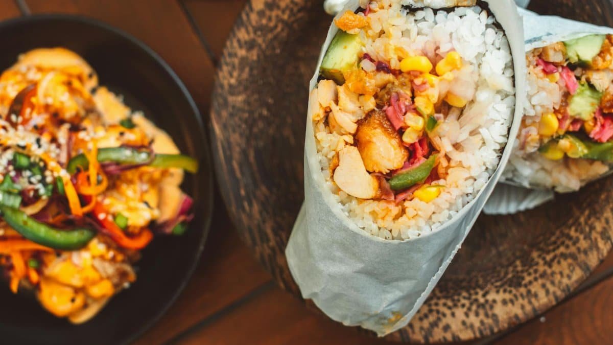 Delicious sushirrito filled with fresh vegetables and rice, perfect for a fusion meal experience.
