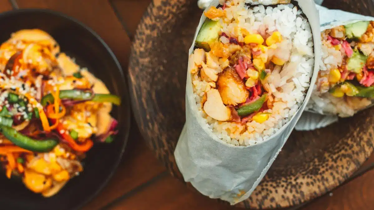 Delicious sushirrito filled with fresh vegetables and rice, perfect for a fusion meal experience.