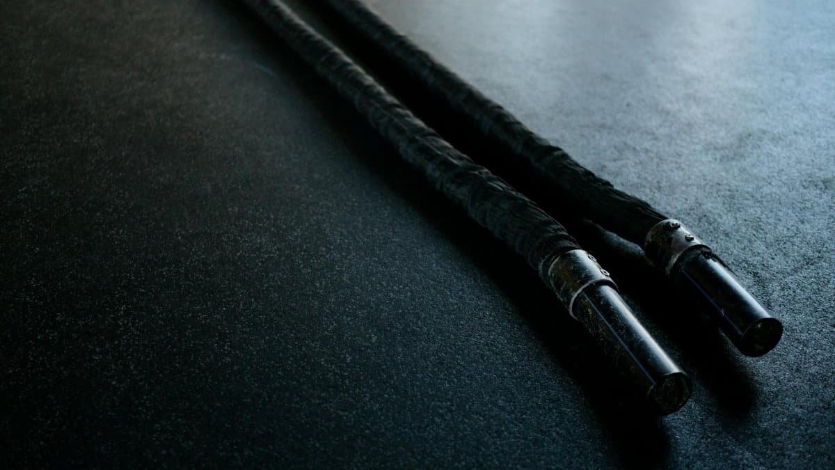 Close-up of battle ropes on a gym floor, ideal for fitness enthusiasts and training setups.
