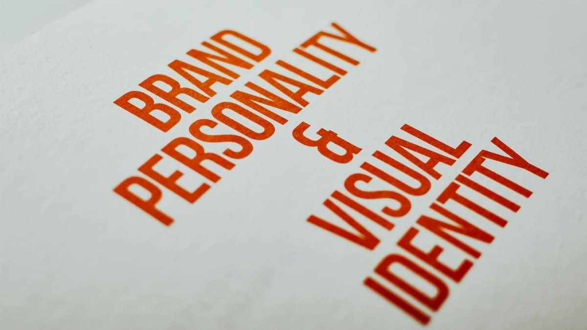Close-up of 'Brand Personality & Visual Identity' text in red on white paper.