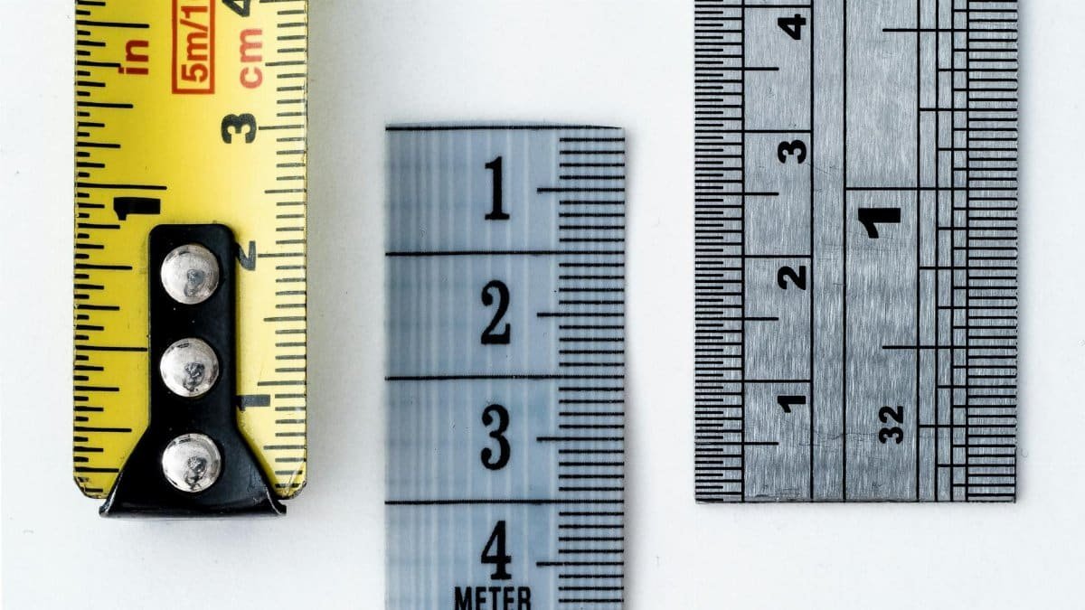 High-resolution image of a tape measure and rulers, showing precise millimeter, centimeter, and inch markings.