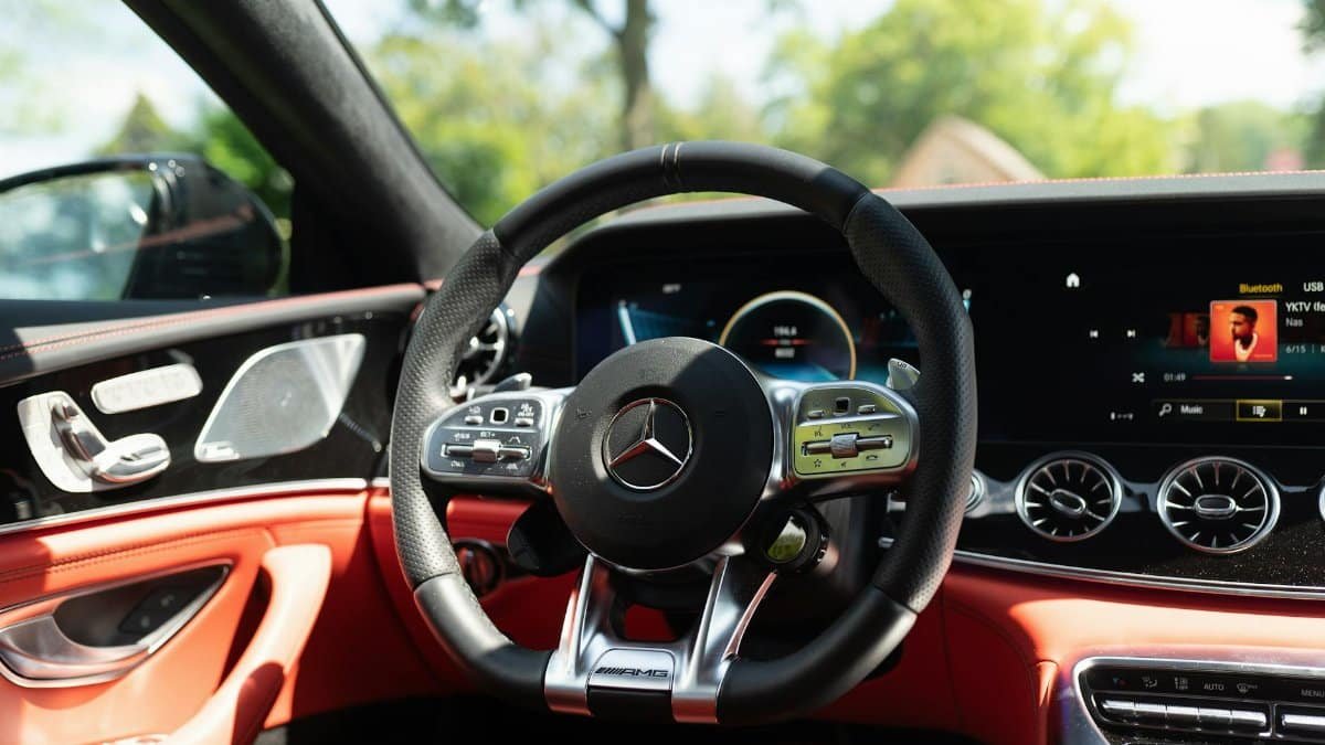 Close-up of a sleek car interior featuring a modern dashboard and high-end steering wheel design.