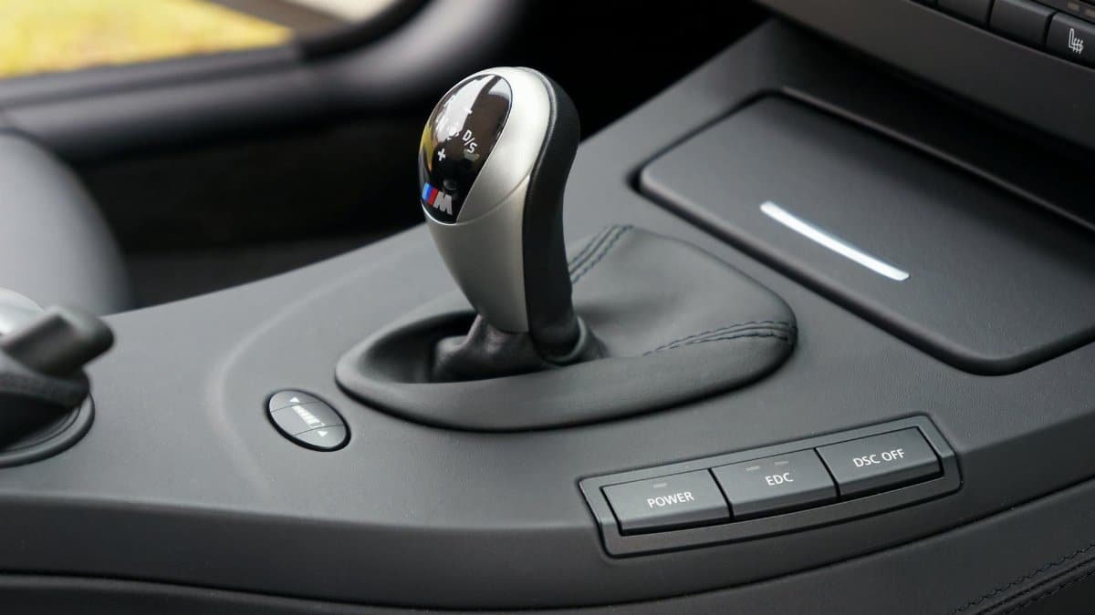 Detailed view of a car gear shift lever inside a luxury vehicle interior.