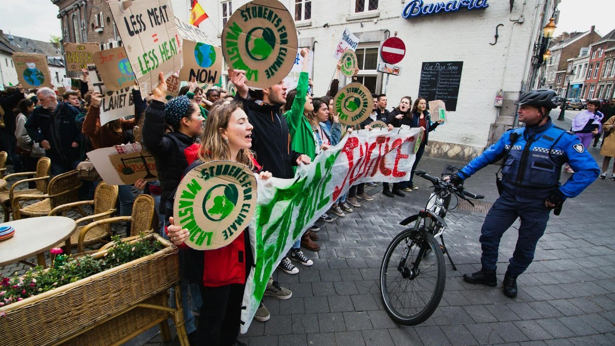 Protesters rally in Maastricht advocating for climate action and environmental justice.