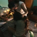 A dedicated home birth support team assists a laboring mother, providing emotional and physical support.