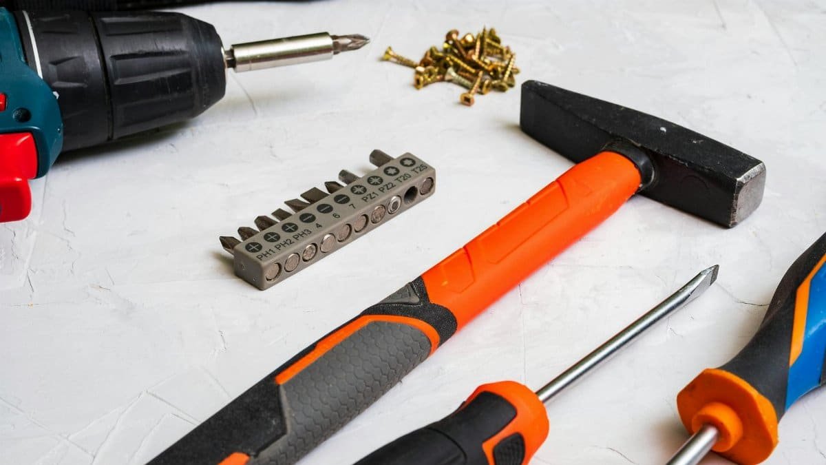 A selection of hand tools including a hammer, screwdriver, and drill bits for home improvement projects.