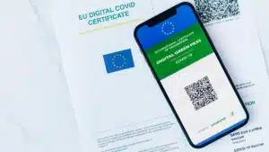 EU Digital COVID Certificate displayed on smartphone and paper form, vaccination proof.