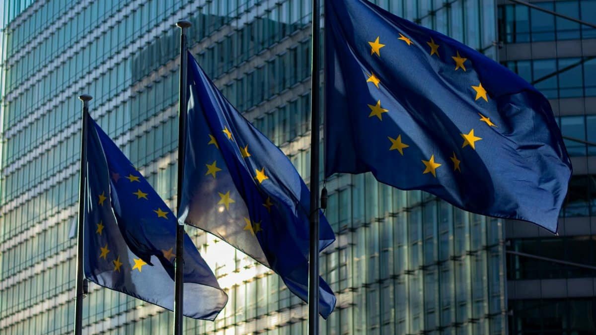 EU flags waving in front of the European Commission building in Brussels, Belgium.