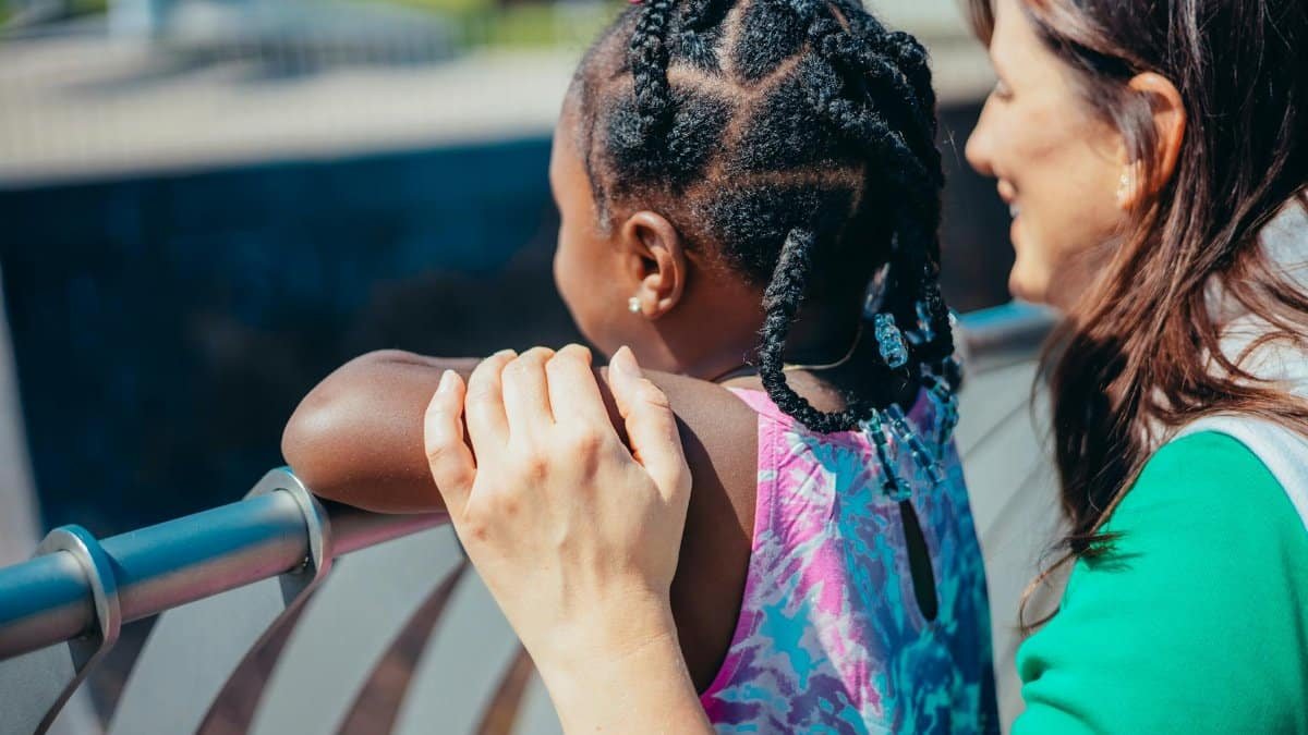 A heartwarming moment between a mother and daughter enjoying time outdoors.