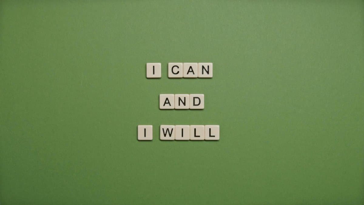 Inspirational message 'I Can and I Will' spelled with tile letters on a green background.