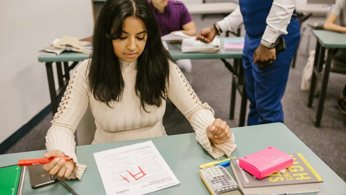 A college student is given an F grade in a classroom setting during an exam.