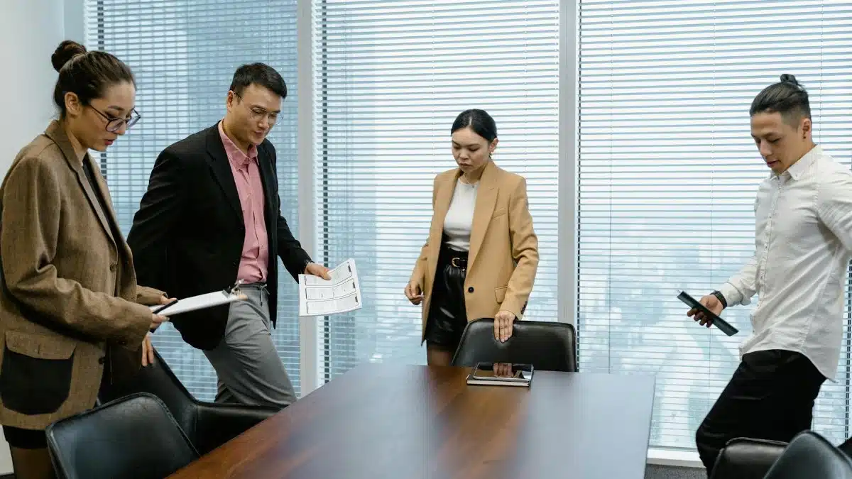 Asian business team having a discussion in a modern office setting.
