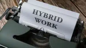 Retro typewriter with 'Hybrid Work' text, symbolizing modern work trends.
