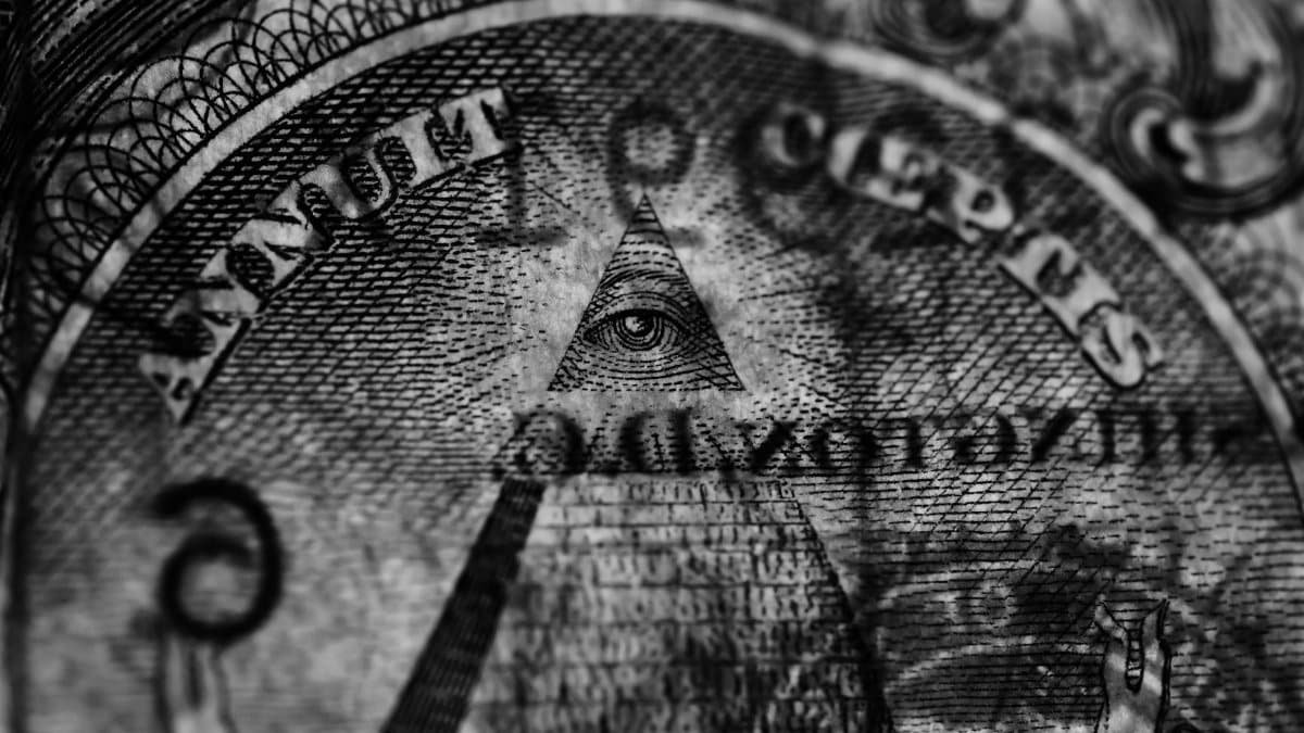 Detailed grayscale image focusing on the Eye of Providence from a US dollar bill.