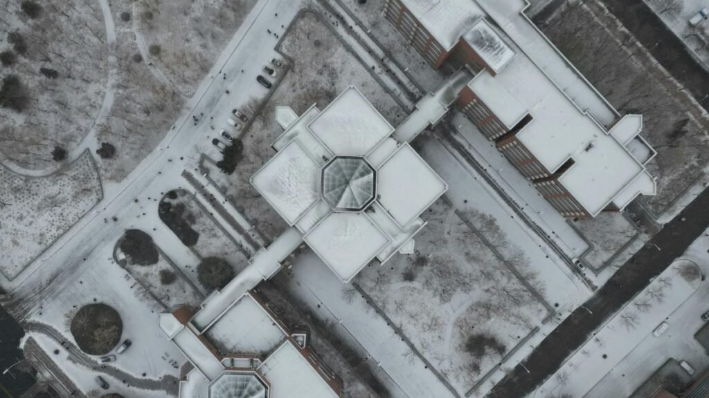 Drone shot of snow-covered buildings and streets in urban Xi Qing Qu, Tian Jin Shi, China.