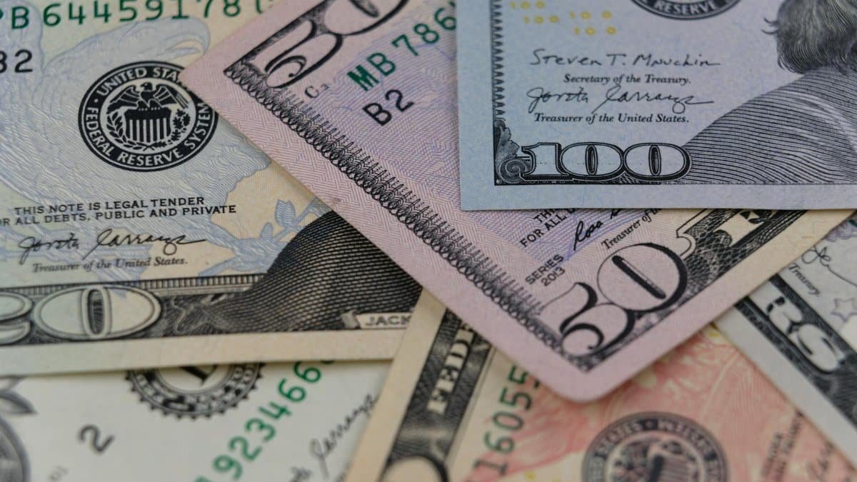 Detailed view of US currency, including $50 and $100 bills, symbolizing finance and economy.