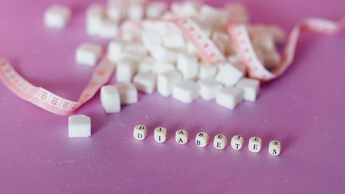 Still life of sugar cubes and diabetes concept with a tape measure, highlighting health awareness.