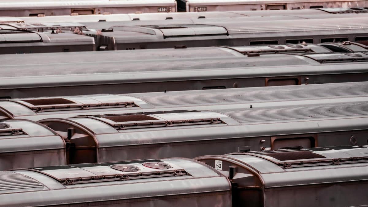 Aerial view of a row of train cars parked at a station in New York City.