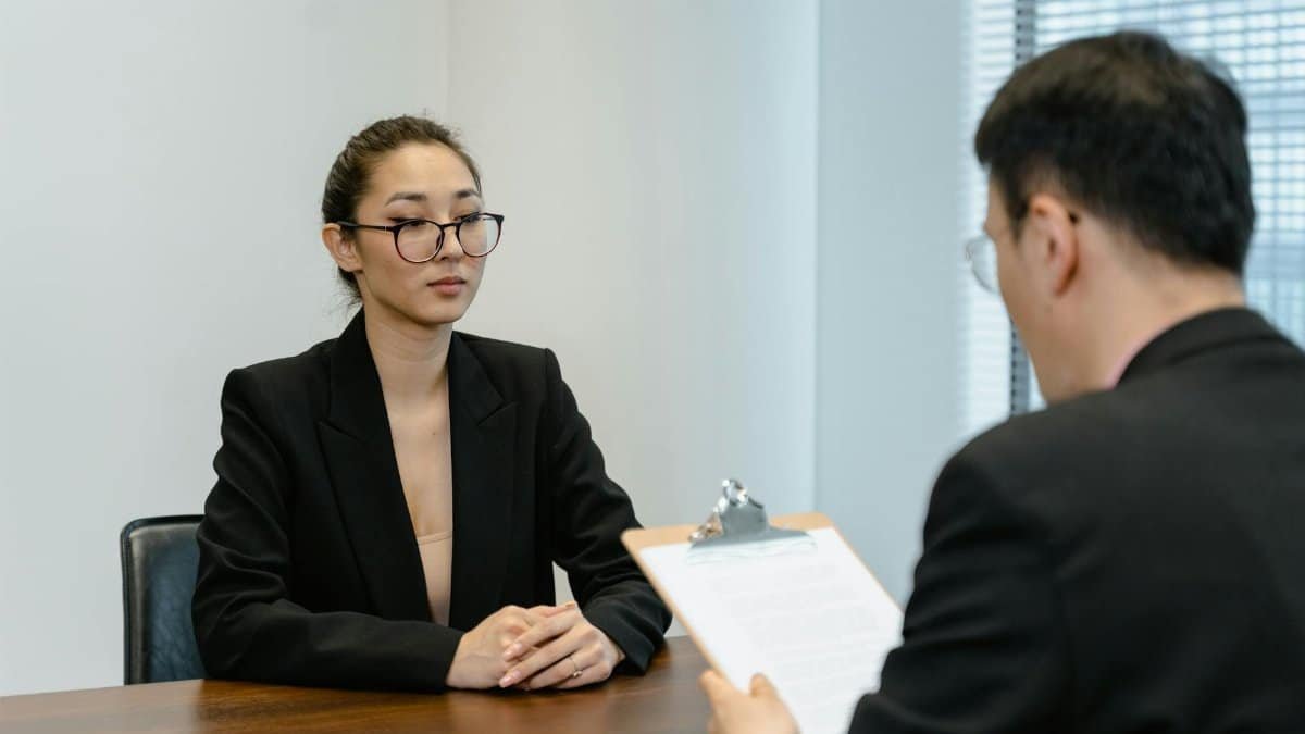 Business interview scene with professionals in office setting.