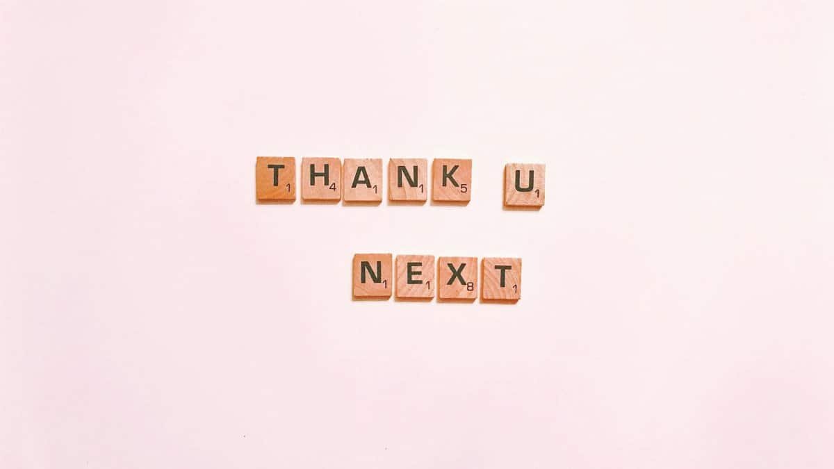Scrabble tiles display 'Thank U Next' on a clean white background, perfect for creative projects.