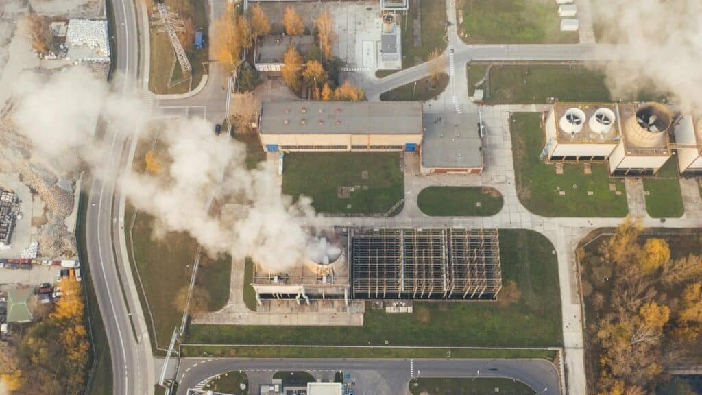 Aerial shot of an industrial area with visible smoke emissions in Poznań, Poland.