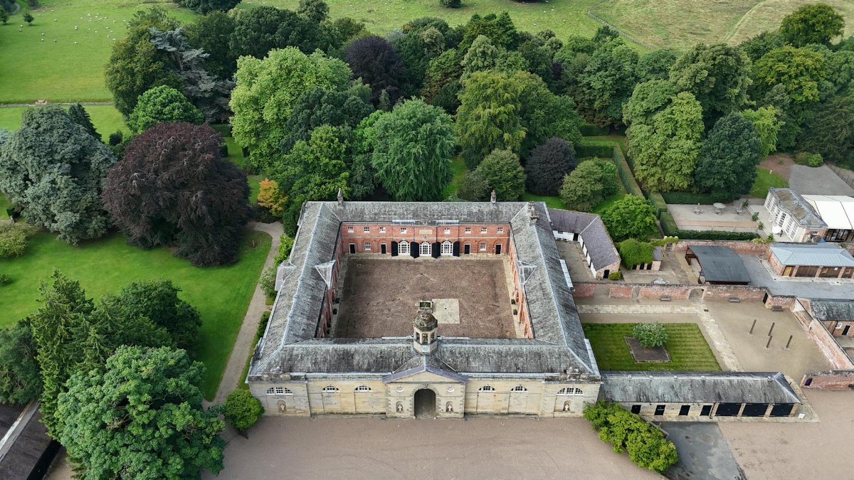Stunning aerial view of Newby Hall surrounded by lush greenery during summer.