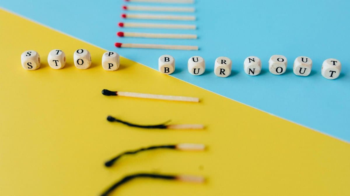 Visual depiction of burnout prevention using dice and matchsticks on colorful surfaces.