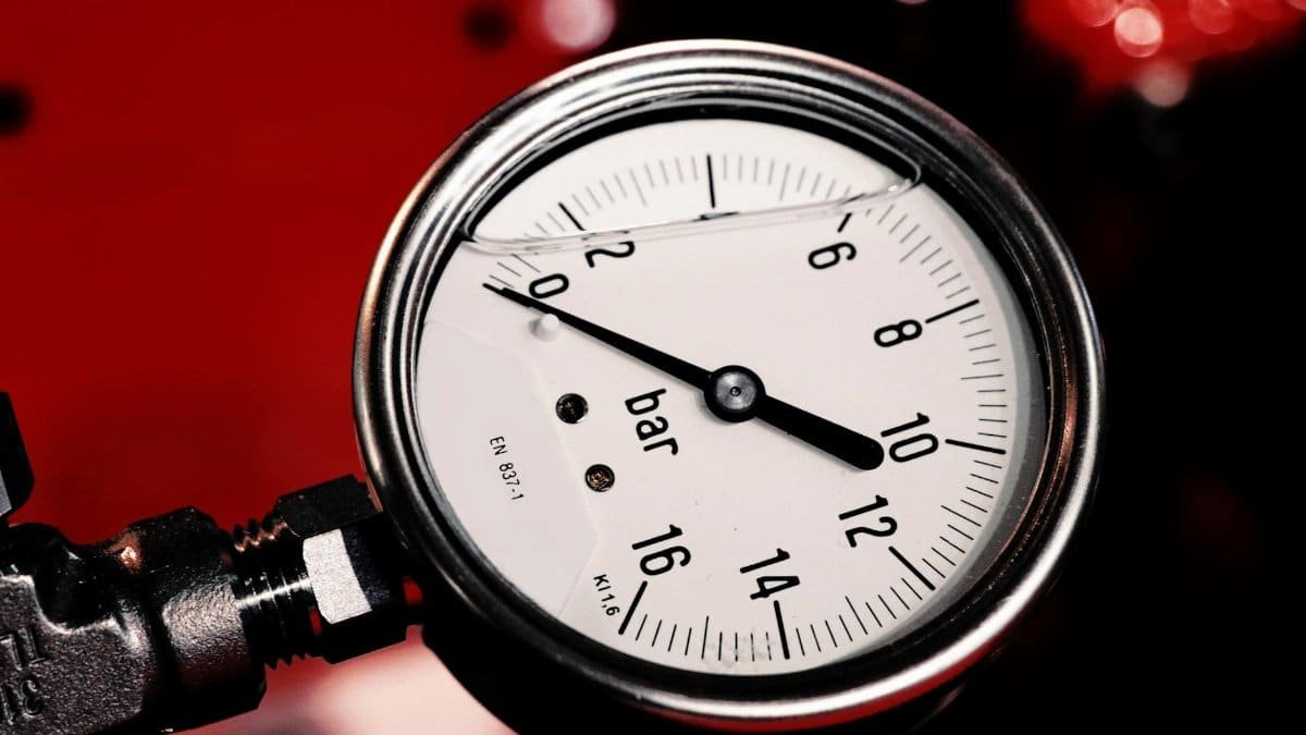 Detailed view of a bar pressure gauge used in industrial settings, emphasizing precision and measurement.