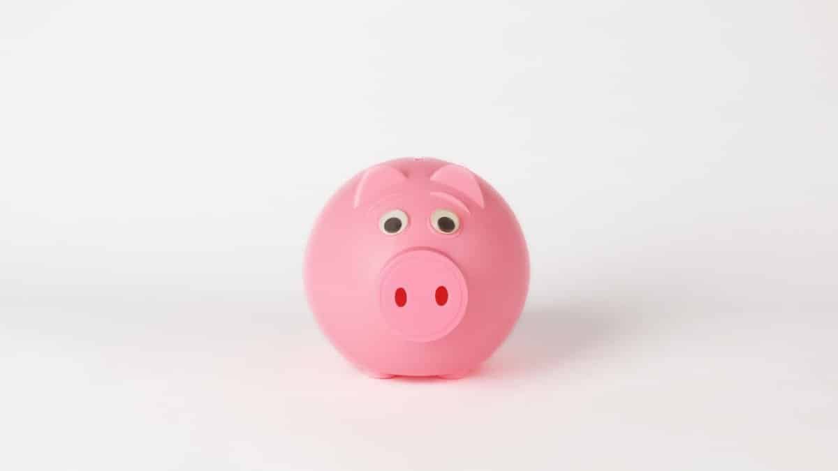 Cute pink piggy bank on a clean white background, symbolizing savings and finance concepts.