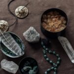 Close-up of spiritual healing crystals and ritual tools on a brown background.