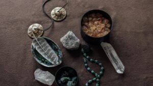 Close-up of spiritual healing crystals and ritual tools on a brown background.