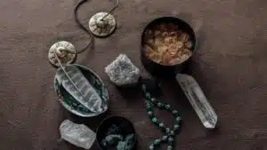 Close-up of spiritual healing crystals and ritual tools on a brown background.