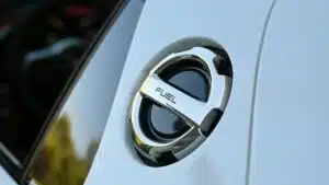 Detailed image of a chrome fuel cap on a luxury vehicle, highlighting sleek design.