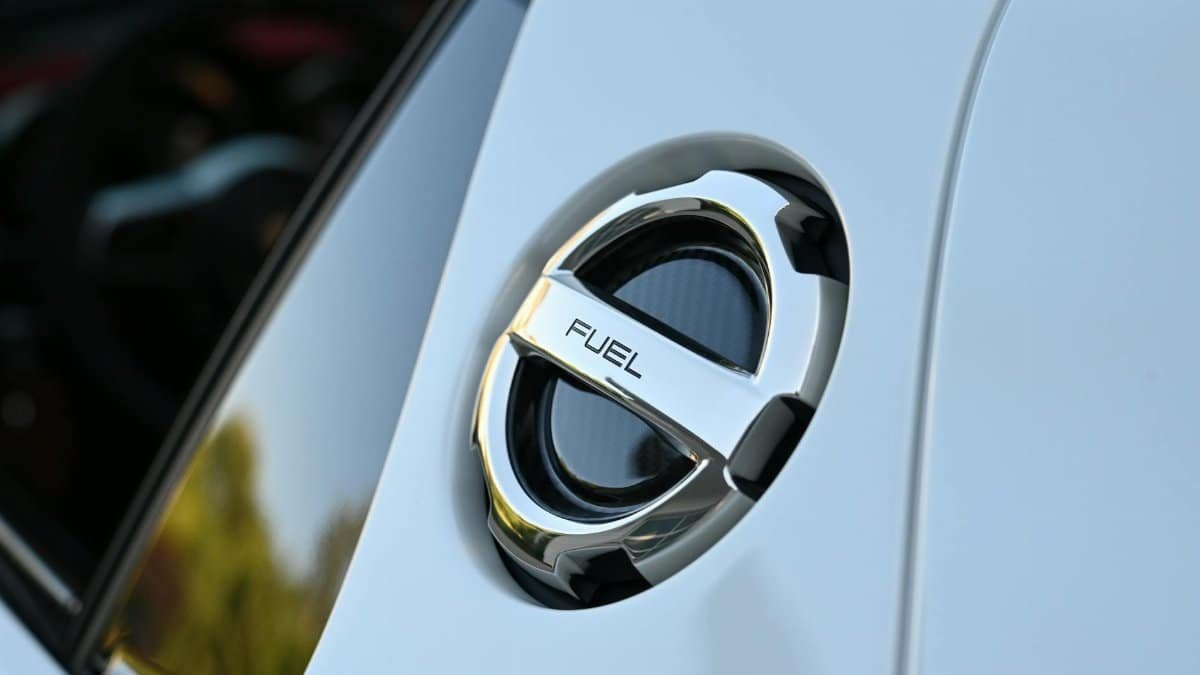 Detailed image of a chrome fuel cap on a luxury vehicle, highlighting sleek design.