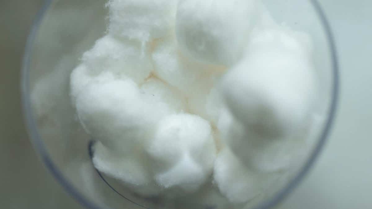 Soft white cotton balls in a glass, perfect for healthcare and beauty applications.